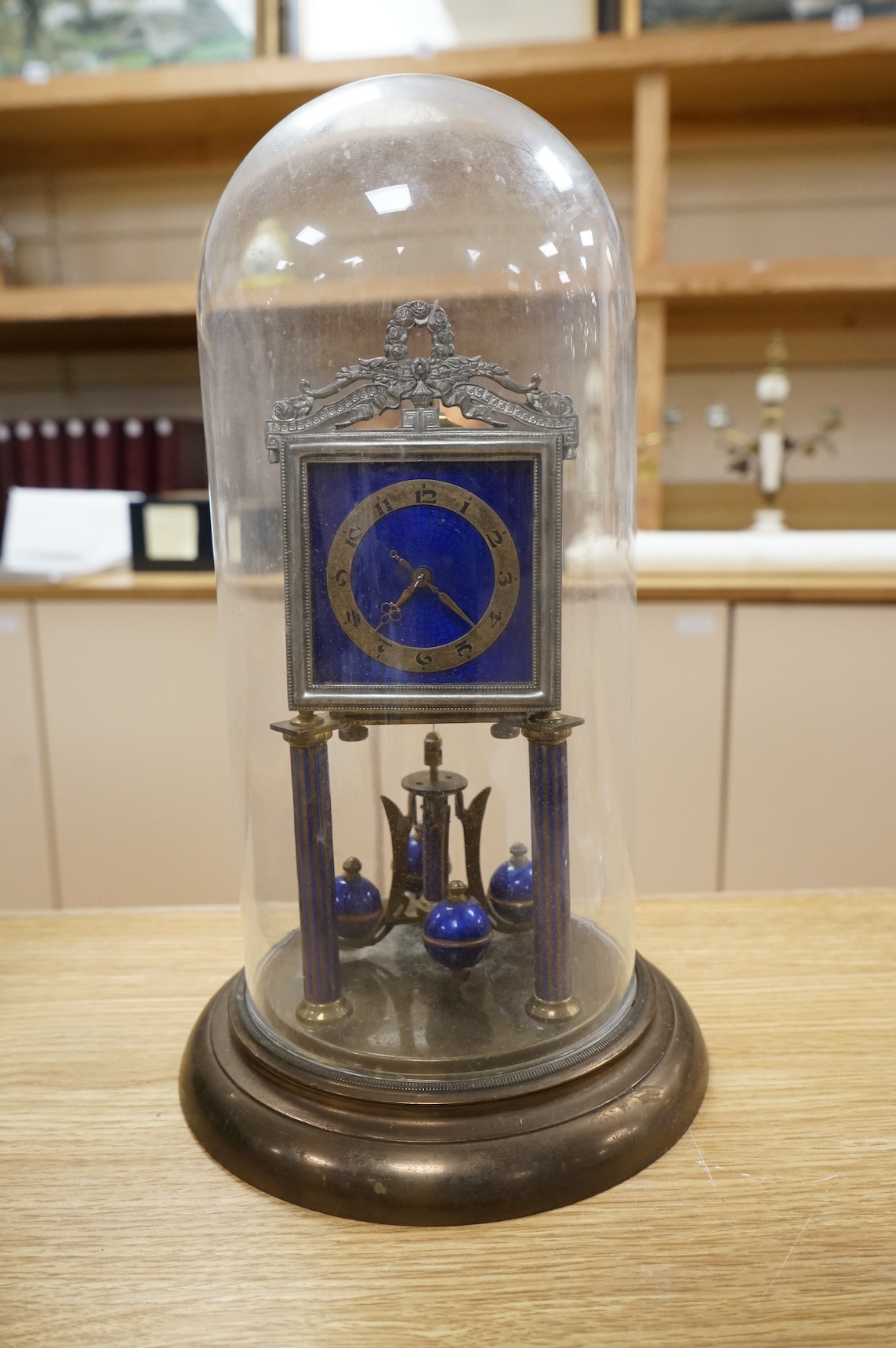 A Jahresuhrenfabrik anniversary clock with blue-enamelled dial, under glass dome, 32cm